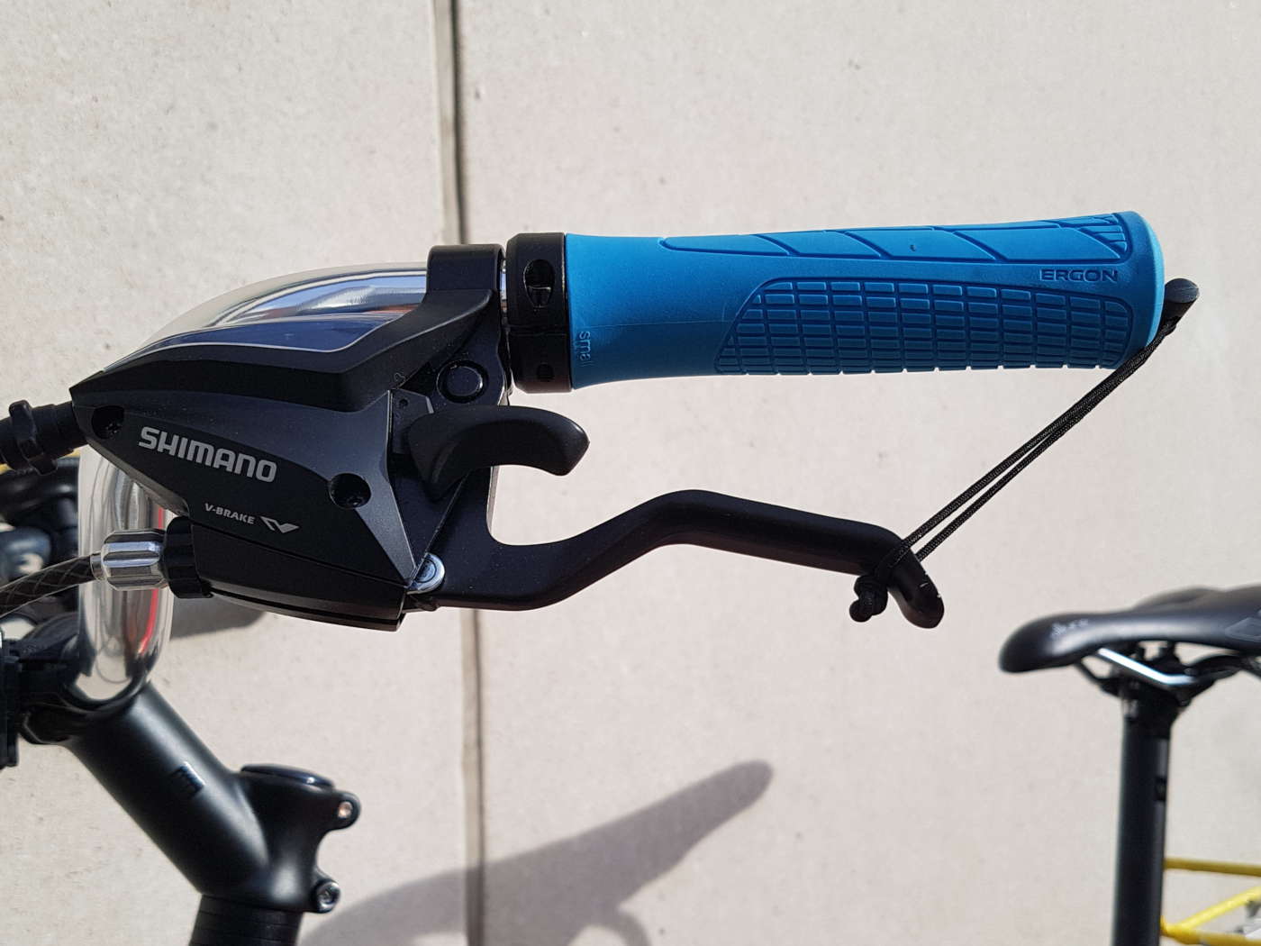 A loop of shock cord wrapped around the brake lever of a bicycle